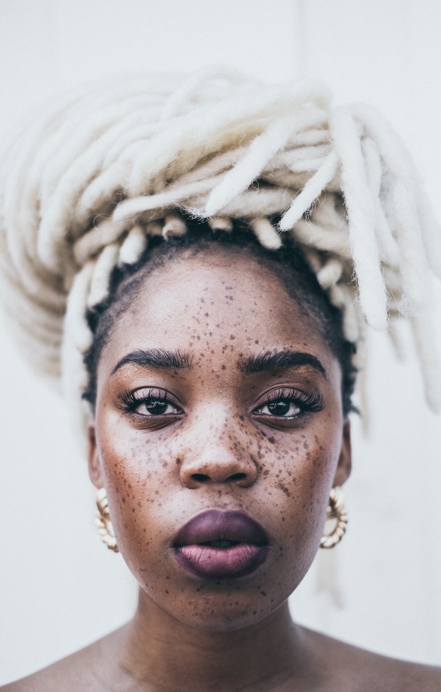 portrait-photo-of-freckled-woman-with-white-braids-posing-3078089